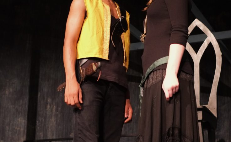 Two actors pose onstage