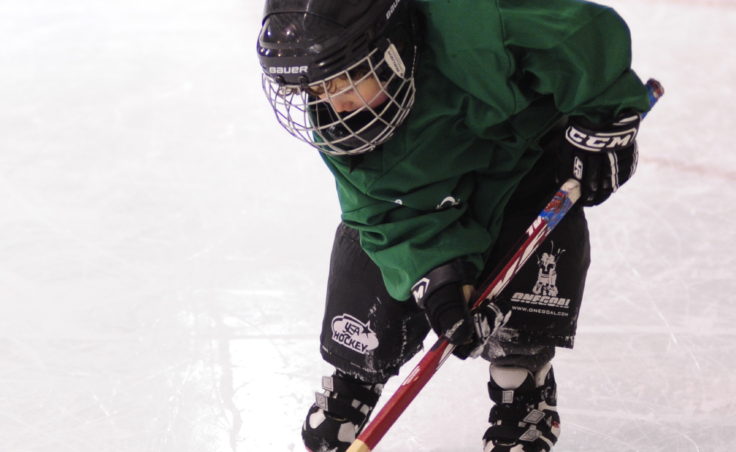 Morgan Sowa swipes at the puck during during JDIA’s Learn to Play event Saturday at Treadwell Ice Arena.