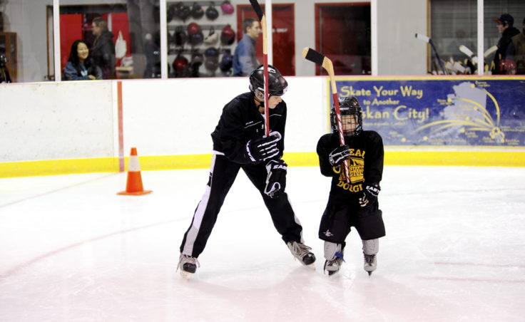 JDIA player Greyson Liebelt demonstrates how to correctly grip a hockey stick during JDIA’s Learn to Play event Saturday at Treadwell Ice Arena.