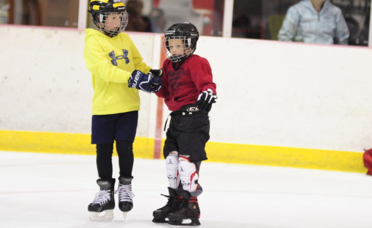 Gabe Miller assists Caleb Friend on the ice during JDIA’s Learn to Play event Saturday at Treadwell Ice Arena. Miller was among many advanced players willing to work with kids skating for the first time.