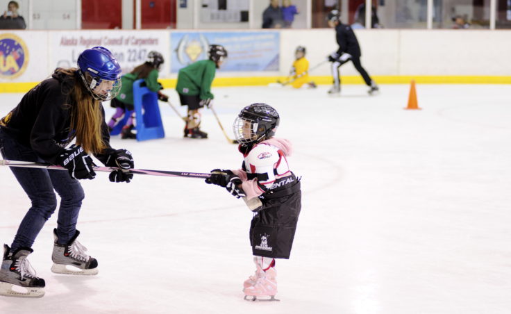 Myrica Wildes pulls Sydney Hood along the ice during JDIA’s Learn to Play event Saturday at Treadwell Ice Arena.