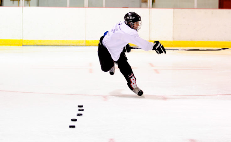 Cahal Morehouse takes a shot on net during a skills test gauging accuracy and speed at the Rocky Mountain Hockey School.