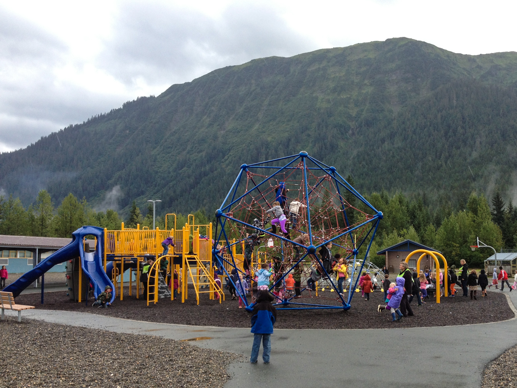 Kids play on the climbing web at Glacier Valley Elementary School.