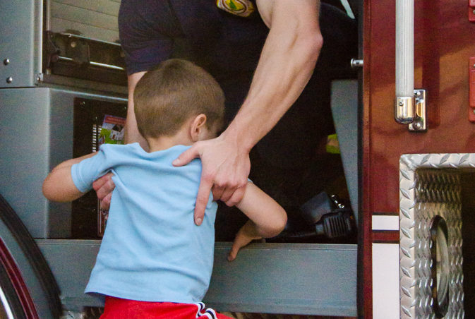 Probationary firefighter Cody Carver assisted dozens of kids in and out of fire trucks throughout the evening.