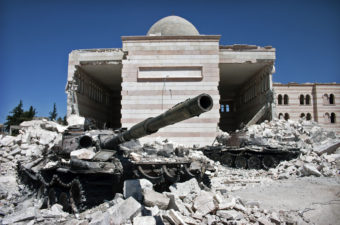 Two destroyed tanks in front of a mosque in Azaz, Syria.