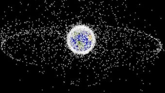 A computer image generated by NASA shows objects orbiting Earth, including those in geosynchronous orbit at a high altitude. The objects are not to scale.