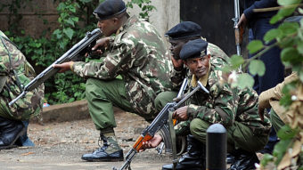 Kenyan police officers take cover outside the Westgate mall in Nairobi on Monday. Simon Maina /AFP/Getty Images