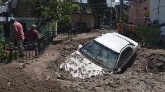 A car lays buried in mud after flooding triggered by Hurricane Manuel in Chilpancingo, Mexico. Alejandrino Gonzalez/AP