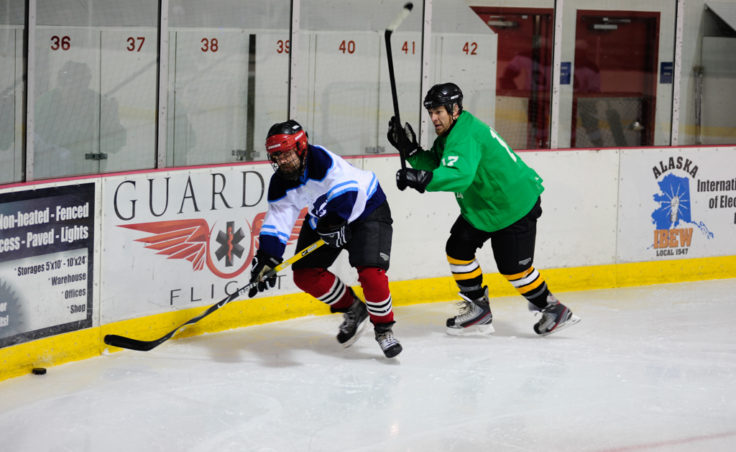 The Green team’s Mason Morriss chases Jason Bluhm around the boards behind the Green team’s net.