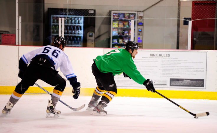 Jared Pique (left) of Alaska Airlines keeps Mason Morriss from getting close to the net in a game against the Green team during a Tier A match on Sunday. Morriss’ team, however, lead his team to a 4-3 victory with a hat trick in the JAHA opener.