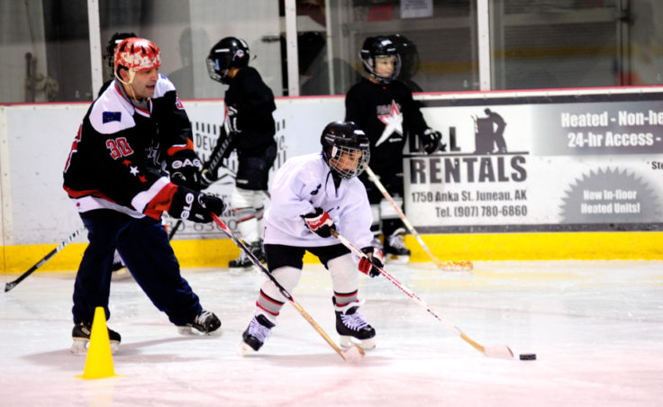Steve MacSwain works closely with players like Ian Moller from the Juneau Douglas Ice Association during his two-day, weekend youth hockey camp.