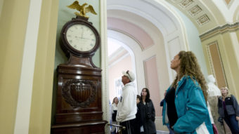 Still Right Twice A Day: Visitors look at the Ohio Clock outside the Senate chamber on Capitol Hill Sunday. The clock that has stood watch over the Senate for 196 years stopped running shortly after noon Wednesday. Employees who wind the clock weekly were furloughed in the federal shutdown. Jose Luis Magana/AP