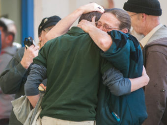 A Sparks Middle School student cries with family members after the shooting in Sparks, Nev. on Monday. Kevin Clifford/AP