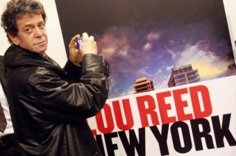 Musician Lou Reed, for decades a rock icon, died Sunday at age 71. In 2006, he took a picture of an ad for his own photo exhibit in Naples. AFP/AFP/Getty Images