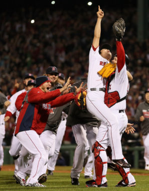 Boston Red Sox relief pitcher Koji Uehara points to the sky as he and his teammates celebrate their World Series victory Wednesday. Rob Carr/Getty Images