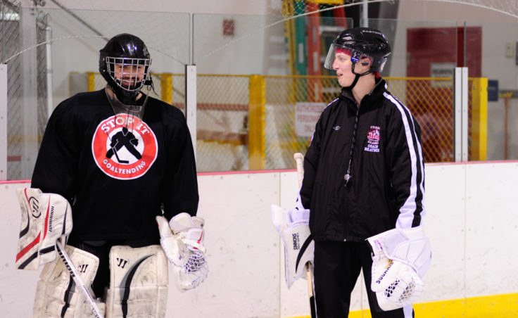 Goaltender coach Heather Strickland chats with player/coach Neal Chapman, who is a varsity goalie for Juneau Douglas High School.