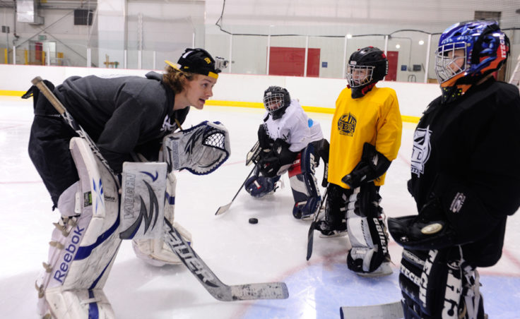 Matt Noreen works with a small group of goalies during JDIA’s skills development camp that attracted nine goalies.