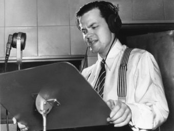 Orson Welles delivering a radio broadcast in 1938, the same year he aired his War of the Worlds fake news program. AP