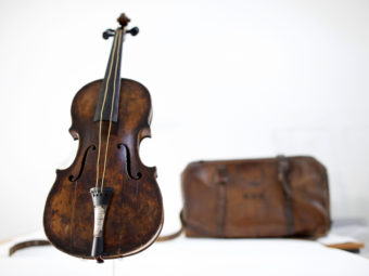 This violin is said to have been played by bandmaster Wallace Hartley during the final moments before the sinking of the Titanic. It's thought he put the instrument in that leather case. Hartley's body and the case were found by a ship that responded to the disaster. Now the violin has been sold. Peter Muhly /AFP/Getty Images