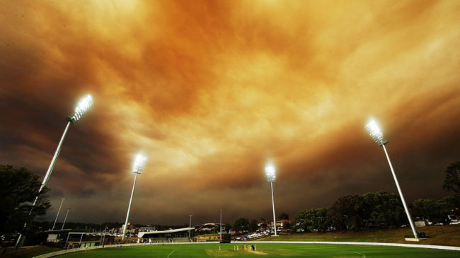 A general view of play as the Sydney skyline is shrouded in smoke during the Ryobi Cup match between the South Australian Redbacks and the Western Australia Warriors at Drummoyne Oval in Australia. Mark Metcalfe/Getty Images