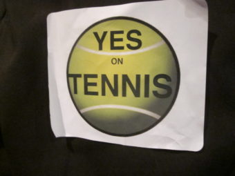 Supporters of building the Northern Lights Recreation Center which would house six indoor tennis courts wore stickers with the words ‘Yes on Tennis’ scrawled across a green tennis ball at the regular meeting of the Anchorage Assembly Tuesday night.