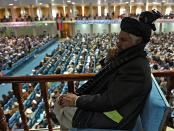A member of the Afghan Loya Jirga listens as the more than 2,000 elders begin debating a proposed U.S.-Afghan security pact on Thursday in Kabul. Massoud Hossaini /AFP/Getty Images