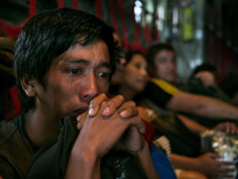 In anguish: Tears ran down the cheeks of a man as he waited with other survivors Tuesday for a flight out of Tacloban, the Philippines, which was devastated by Typhoon Haiyan. Paula Bronstein/Getty Images