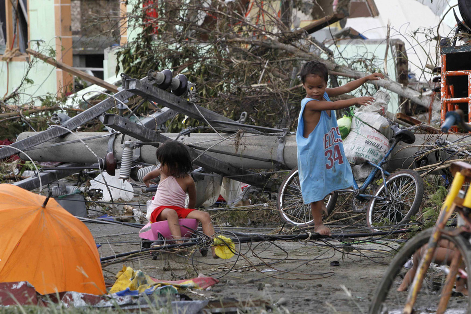 Children play near electric posts which were damaged after super Typhoon Haiyan battered Tacloban city in the central Philippines. Romeo Ranoco /Reuters /Landov