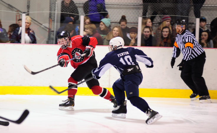 Juneau left wing Cole Cheeseman unleashes a shot in a crowd of opposing players from Soldotna during the team’s season opening series versus Soldotna at Treadwell Ice Arena.