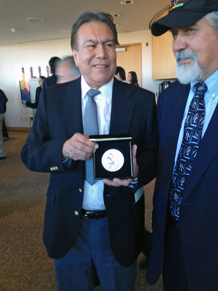 Robert “Jeff” David Jr., left, holds the silver medal awarded to his dad, who the family just learned was a code talker. David, of Haines, traveled to Washington, DC with former legislator Bill Thomas. Photo by Liz Ruskin, APRN – Washington DC.
