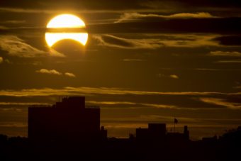 A partial Solar eclipse is seen just after sunrise over the Queens borough of New York across the East River on Sunday in New York. Stan Honda /AFP/Getty Images
