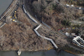 A Metro-North passenger train derailed in the Bronx borough of New York on Sunday, coming to a rest just feet from the water. Authorities say four people were killed and 63 injured. Mark Lennihan/AP