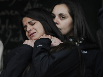 Erica Lafferty (right), daughter of Sandy Hook Elementary School shooting victim Dawn Hochsprung, consoles Carlee Soto, sister of victim Victoria Soto, after representatives of 14 families addressed the media on Monday in Newtown, Conn. Jessica Hill/AP
