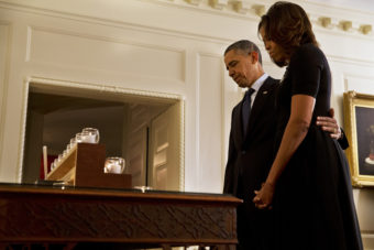 President Obama and first lady Michelle Obama take a moment of silence in honor of the Newtown shooting victims on the one year anniversary of the tragedy. Jacquelyn Martin/AP