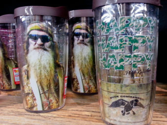 Duck Dynasty plastic drinking glasses with Phil Robertson's image are among the merchandise on sale at the Duck Commander store in West Monroe, La., and at other businesses around the nation. Matthew Hinton/AP