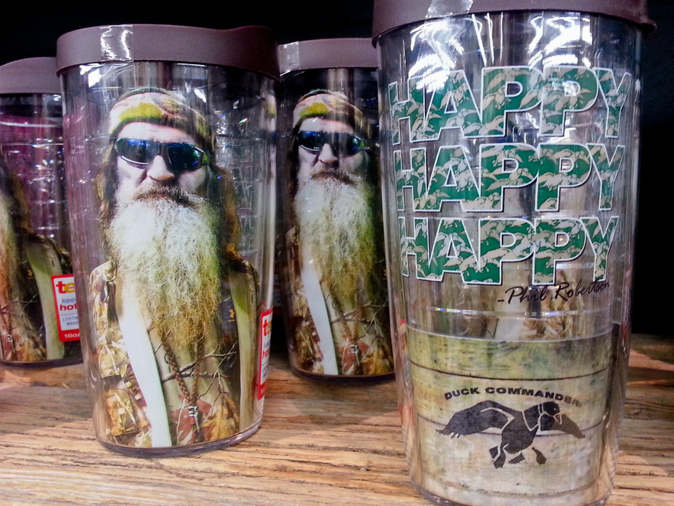 Duck Dynasty plastic drinking glasses with Phil Robertson's image are among the merchandise on sale at the Duck Commander store in West Monroe, La., and at other businesses around the nation. Matthew Hinton/AP