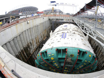 In this photo made with a fish-eye wide-angle lens, Bertha, the massive boring machine that is drilling a two-mile tunnel under Seattle, is shown in July before work began. The tunnel will replace a double deck highway along the downtown Seattle waterfront. Ted S. Warren/AP
