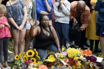 A woman prays outside the house of former South African President Nelson Mandela in Johannesburg on Friday, the day after his death. Stephane de Sakutin /AFP/Getty Images