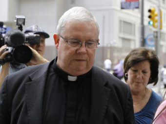 Monsignor William Lynn walks to the Criminal Justice Center before a scheduled verdict reading, on June 22, 2012, in Philadelphia. (Matt Rourke/AP)