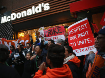 Protesters demonstrate at a McDonald's in New York on Dec. 5. Protesters staged events in cities nationwide, demanding a pay raise to $15 per hour for fast-food workers and the right for them to unionize. (John Moore/Getty Images)