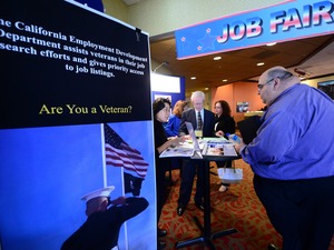 A prospective job seeker gets information at a job resource fair for military veterans in Van Nuys, Calif., on Oct. 24. Frederic J. Brown/AFP/Getty Images