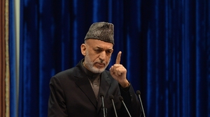 Afghan President Hamid Karzai addresses the Loya Jirga on Sunday. Karzai expressed anger at an airstrike Thursday that killed a child, saying it could imperil a security agreement with the U.S. The U.S.-led international force apologized on Friday for the killing. Massoud Hossaini/AFP/Getty Images