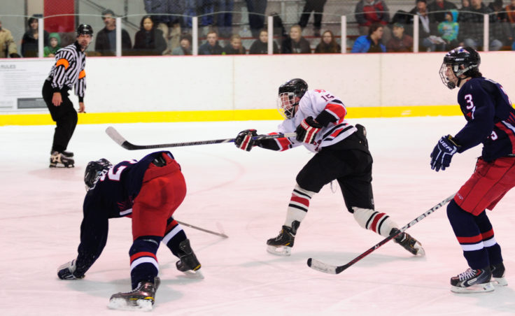 After evading two North Pole defenders, Juneau left winger/defenseman Cole Cheeseman gets a shot off during the two-game series at Treadwell Ice Arena.
