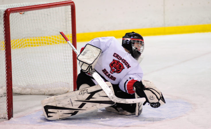Juneau goalie Liam McDermott gets a glove on a North Pole shot during Saturday’s game at Treadwell Ice Arena.