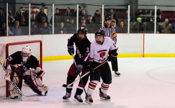 Juneau forward Zach Easton battles for position in front of the net with North Pole’s Carson Linnell.