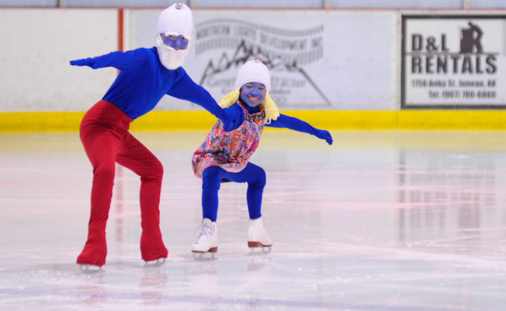 Kara Hort (left) and Ema Jessen bring a little Smurf into the Juneau Skating Club’s holiday recital.