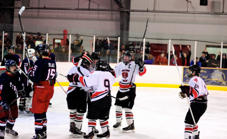 Juneau celebrates Zach Hebert’s goal on Friday to keep his team from being shut out in the 4-1 setback to North Pole at Treadwell Ice Arena.