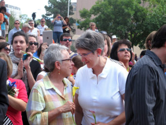 Gail Stockman, 60 (left), and Beth Black, 58, of Albuquerque, N.M., prepare to marry at a massive wedding in August, along with other same-sex couples. Russell Contreras/AP