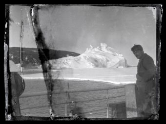 Alexander Stevens, Shackleton's chief scientist, looks south from the deck of the Aurora. Hut Point Peninsula on Ross Island, Antarctica, can be seen in the background. nzaht.org