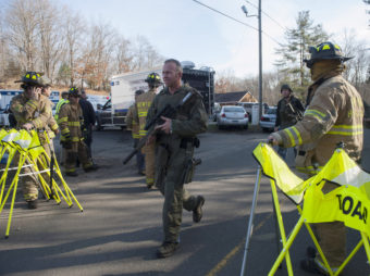 Connecticut State Police walk near the scene of the Sandy Hook Elementary School shooting on Dec. 14, 2012, in Newtown. Douglas Healey/Getty Images